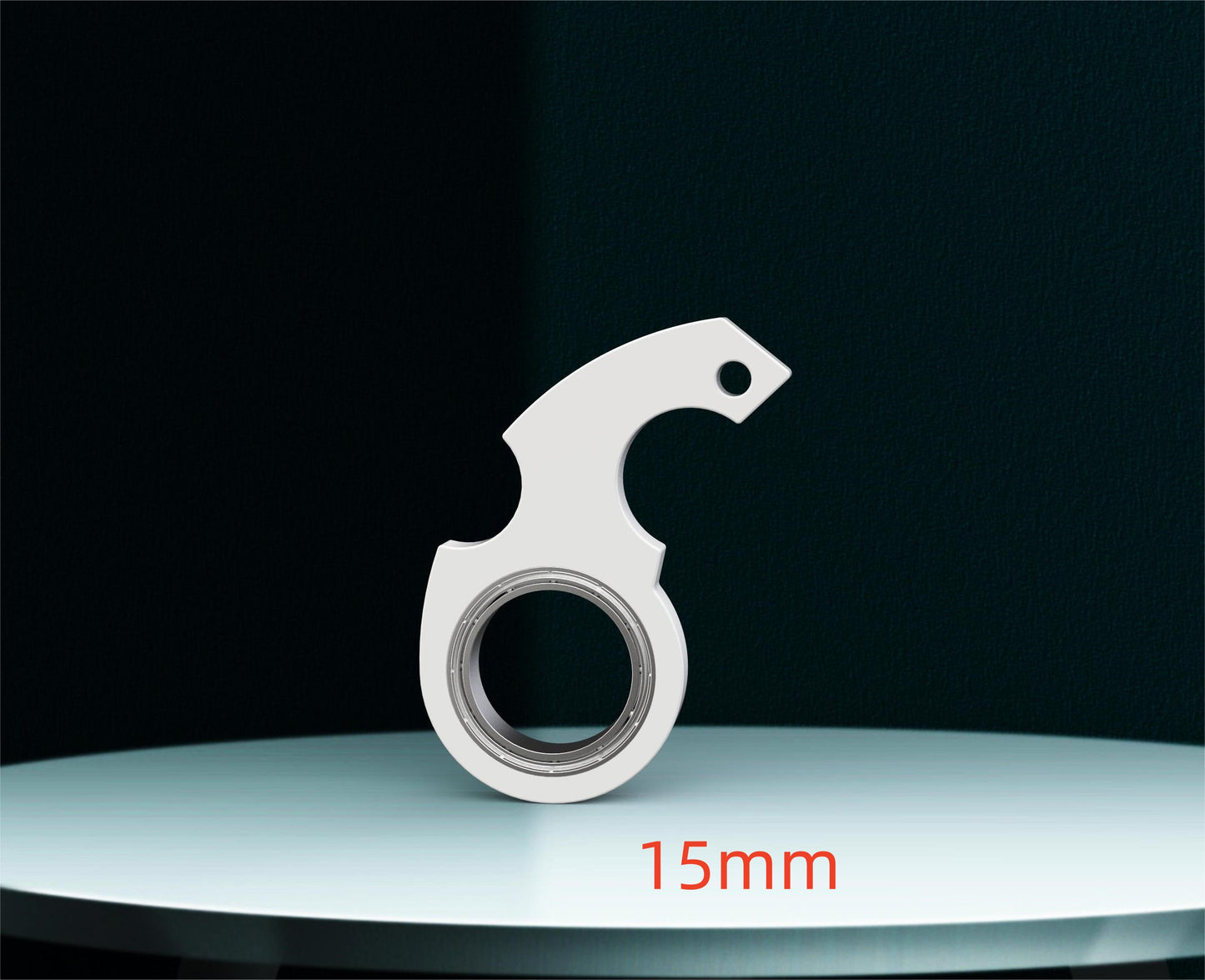 Metallic tool with '15mm' marking on a reflective surface and black background