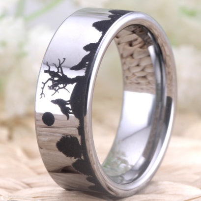 Silver ring with black tree engraving on a natural background