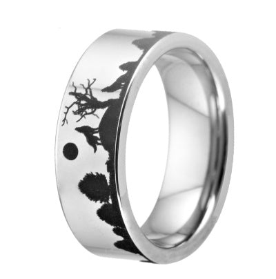 Silver ring with black engraved design on a white background