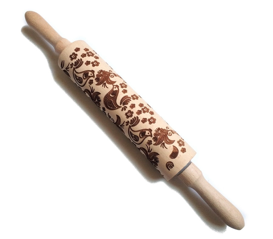 Wooden rolling pin with floral pattern on a white background