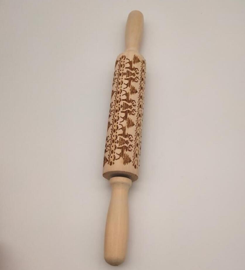 Wooden rolling pin with engraved design on a light gray background
