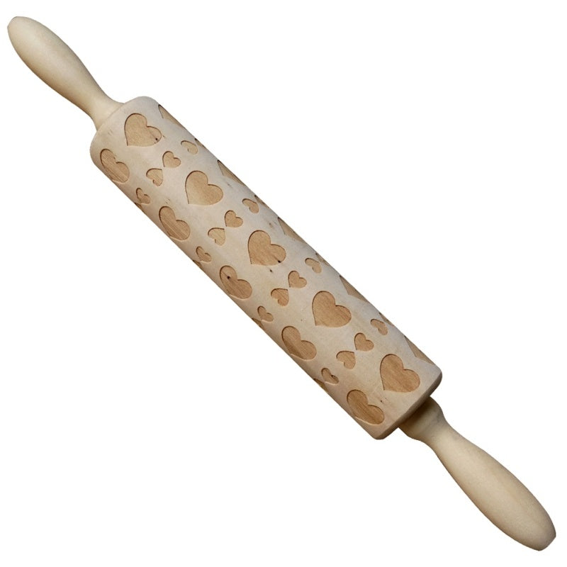 Wooden rolling pin with heart patterns on a white background
