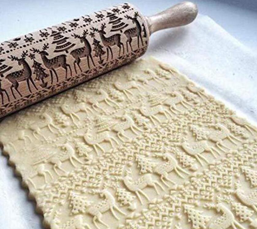 Rolling pin with deer design on a sheet of dough