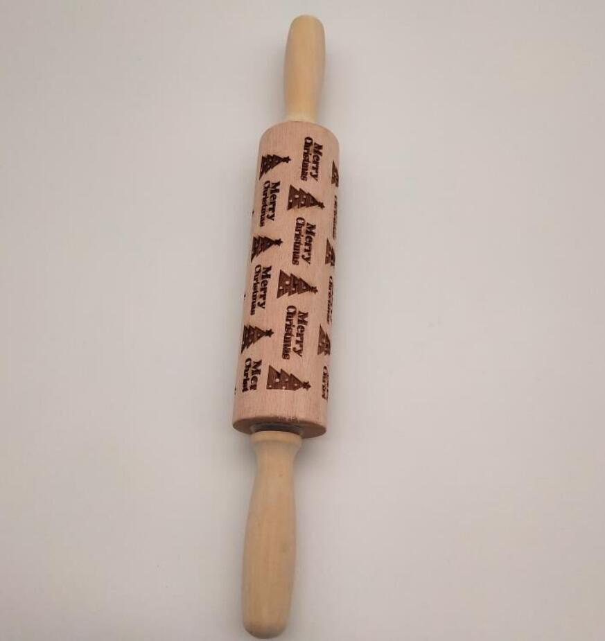 Wooden rolling pin with engraved design on a white background