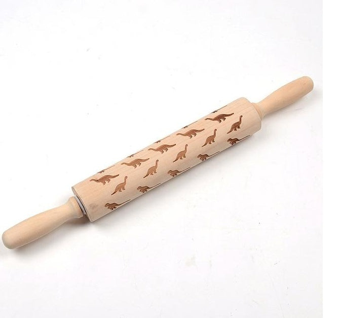 Wooden rolling pin with dinosaur pattern on a white background