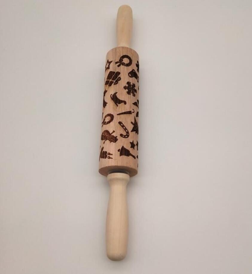 Wooden rolling pin with embossed designs on a light gray background