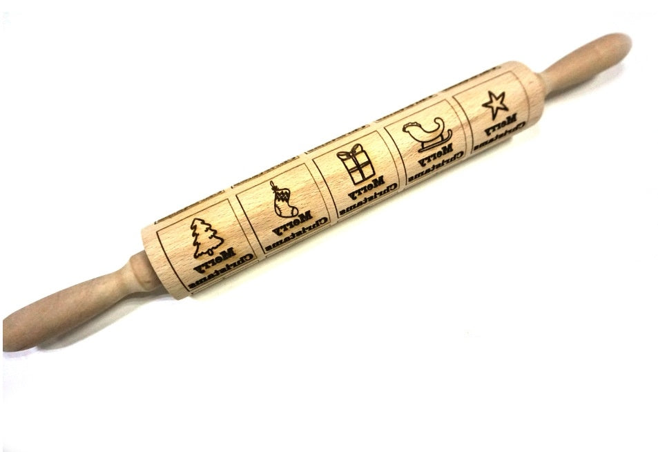 Wooden rolling pin with engraved designs on a white background