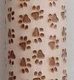 Decorative item with paw print pattern on a textured surface