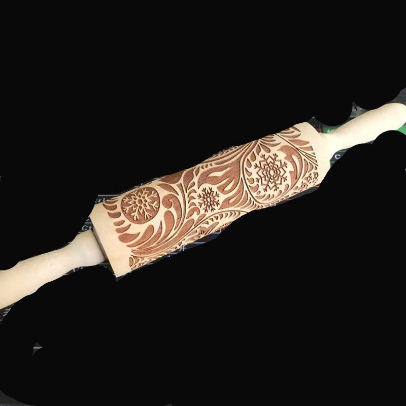 Decorative rolling pin with floral patterns on a black background