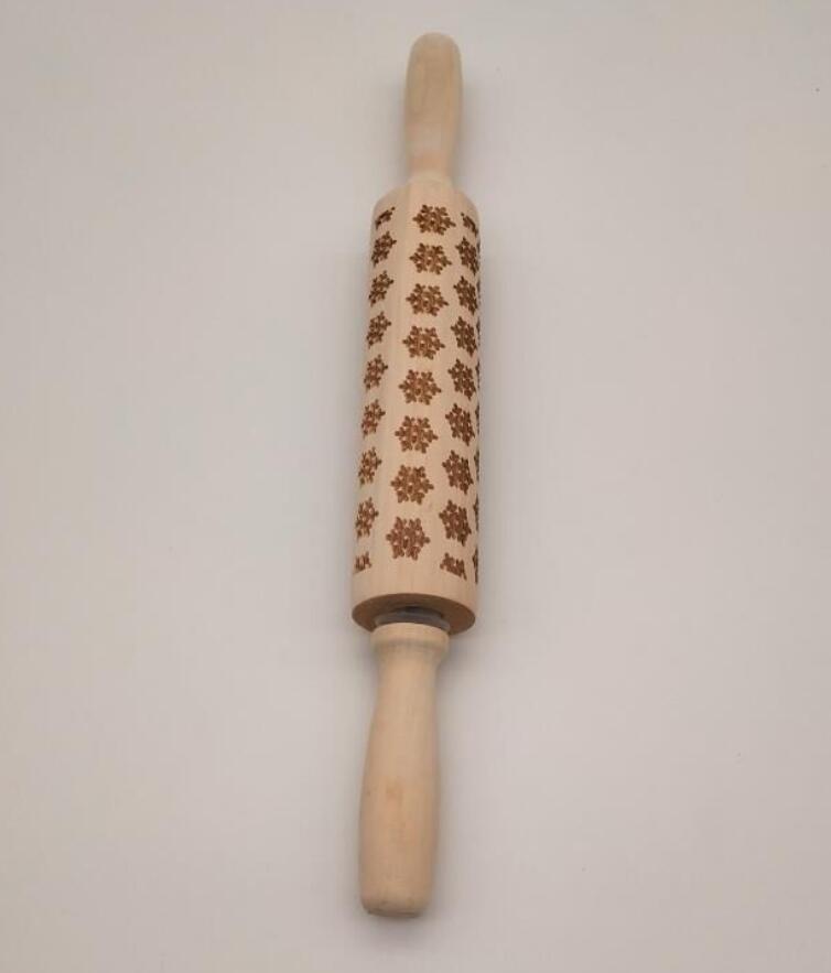 Wooden rolling pin with floral patterns on a white background
