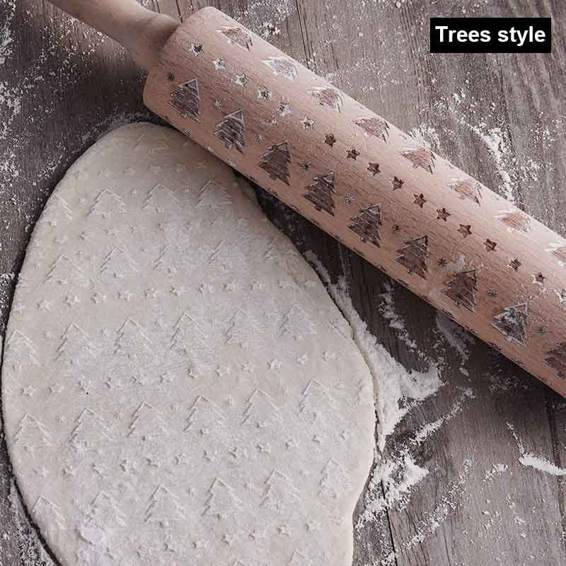 Rolling pin with tree pattern on a wooden surface with rolled-out dough