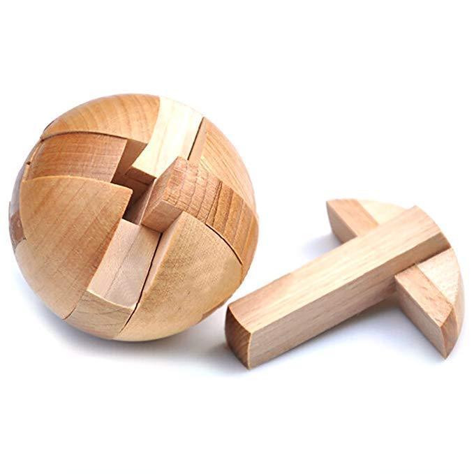 Wooden spherical puzzle with one piece removed on a white background