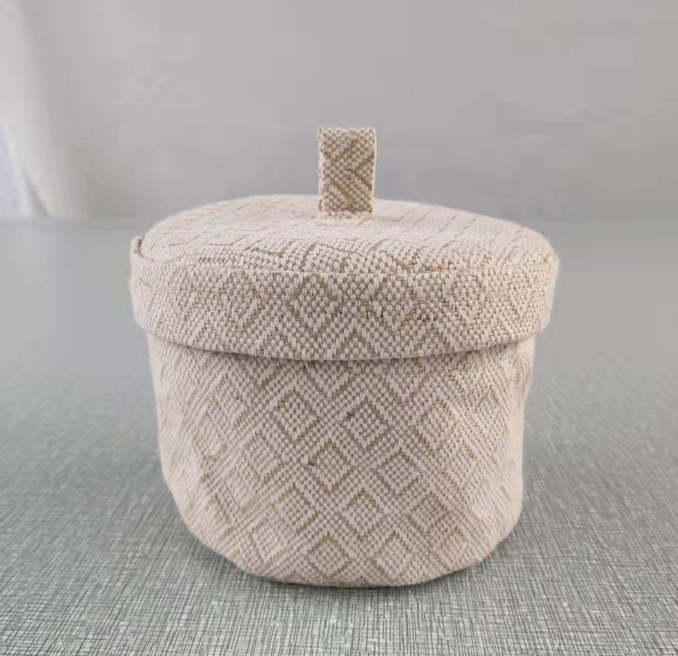 Textured storage basket with a lid on a gray surface