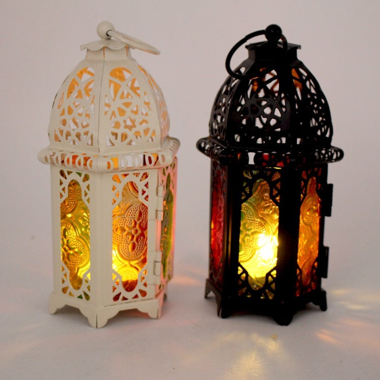 Two decorative lanterns, one white and one black, with intricate designs and glowing lights on a light gray background.
