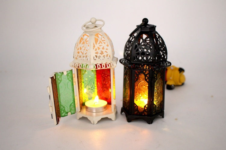 Two ornate lanterns with lit candles inside on a white background