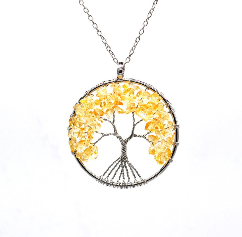 Tree-shaped pendant with yellow stones on a white background
