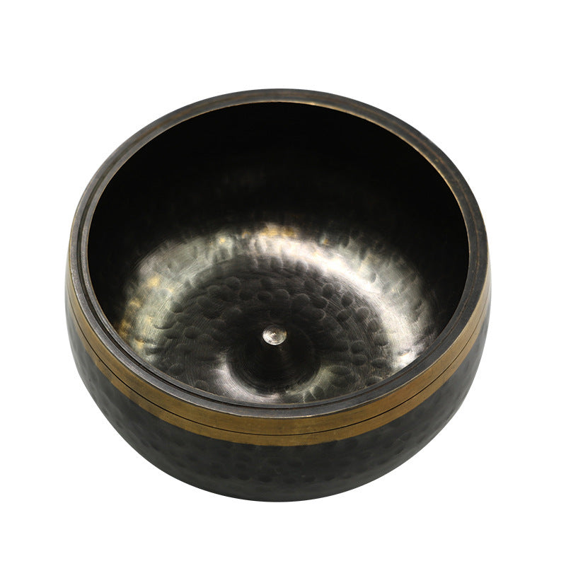 Black metal bowl with textured interior on a white background