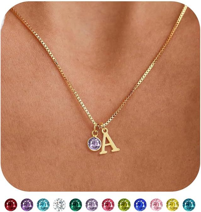 Gold necklace with a purple gemstone and letter 'A' pendant on a skin-toned background.