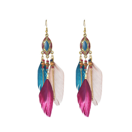 Colorful feather earrings with gemstones on a white background from Nested Wisdom