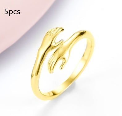 Gold ring with a unique design on a light gray background