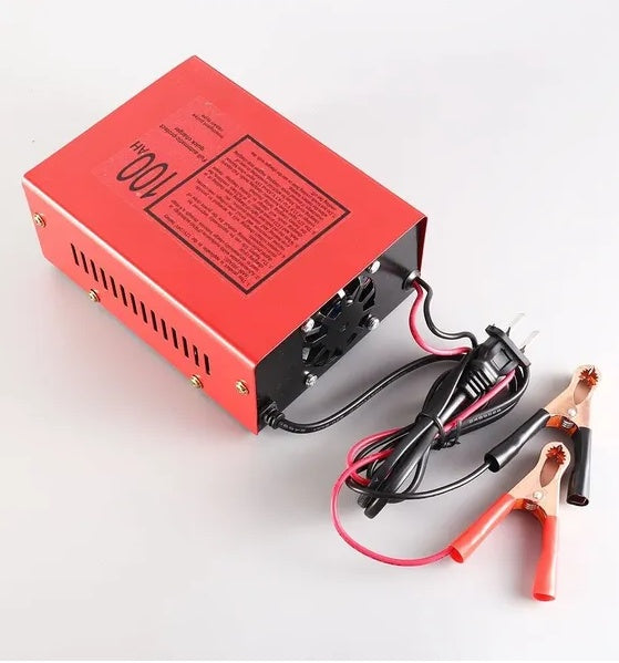 Red battery charger with cables and clamps on a white background