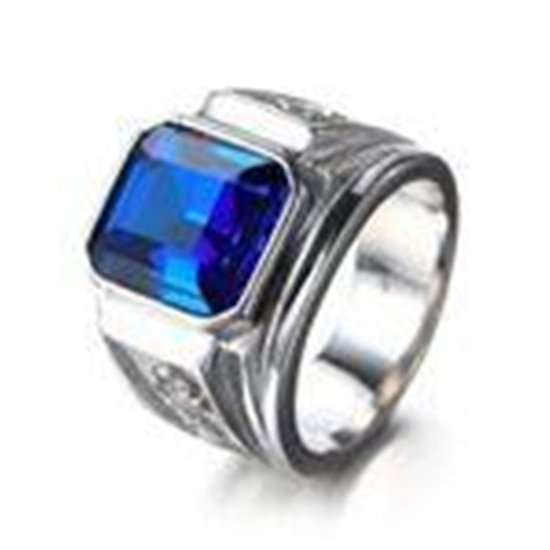 Silver ring with a blue gemstone on a white background