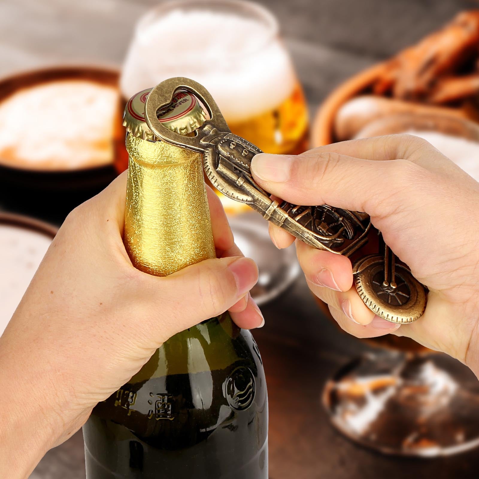 Person using a decorative bottle opener to open a bottle of champagne with a glass of champagne in the background.