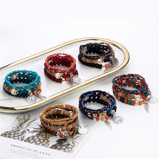 Set of beaded bracelets with charms on a decorative tray