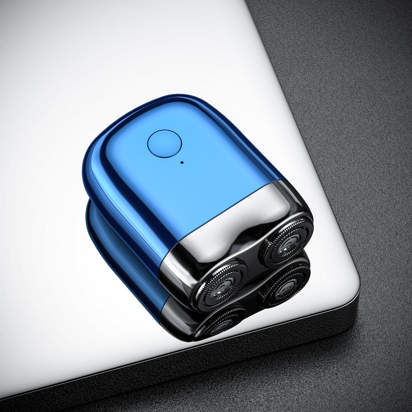 Blue and black electronic device on a reflective surface