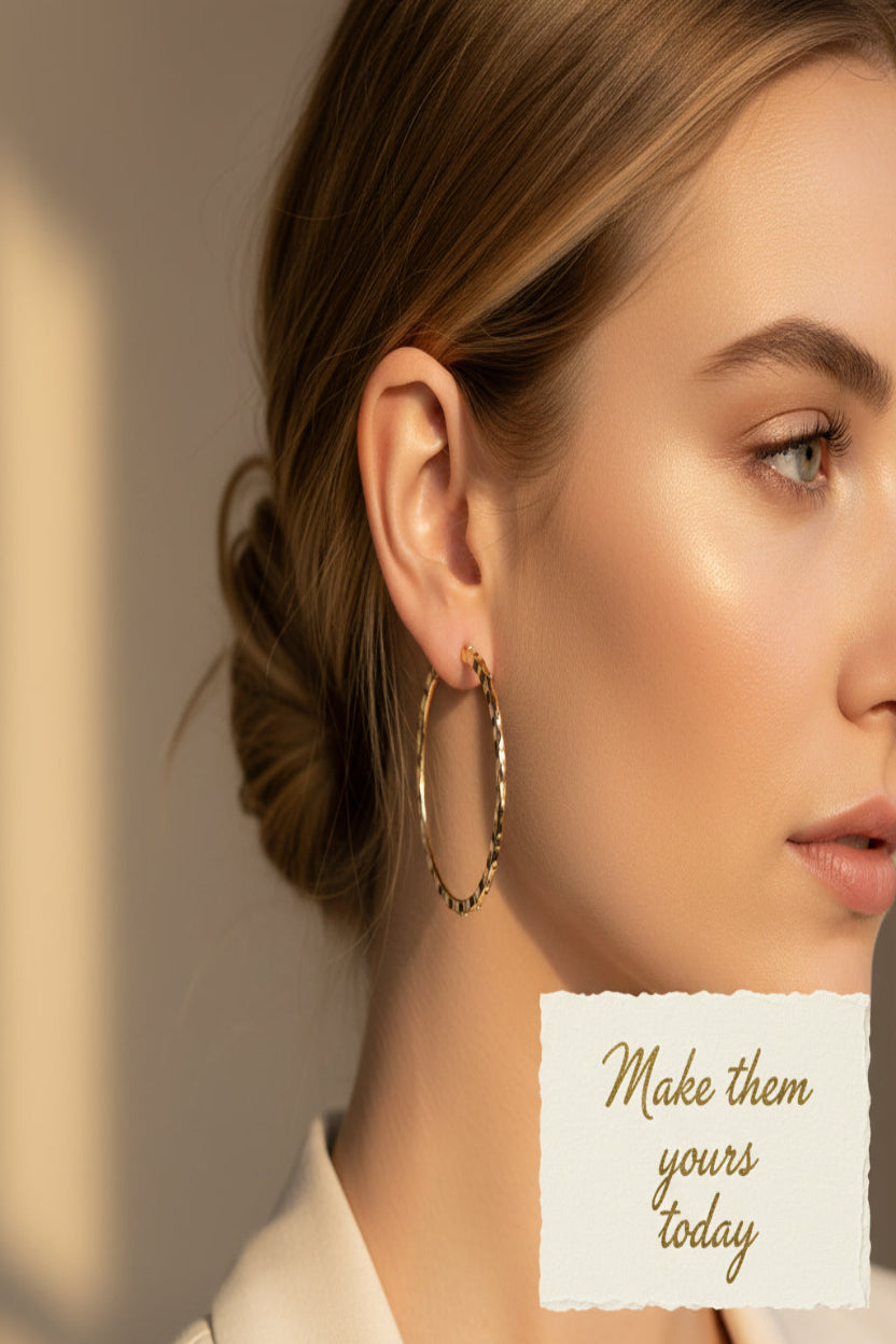 Gold hoop earrings with beaded detailing on a white background