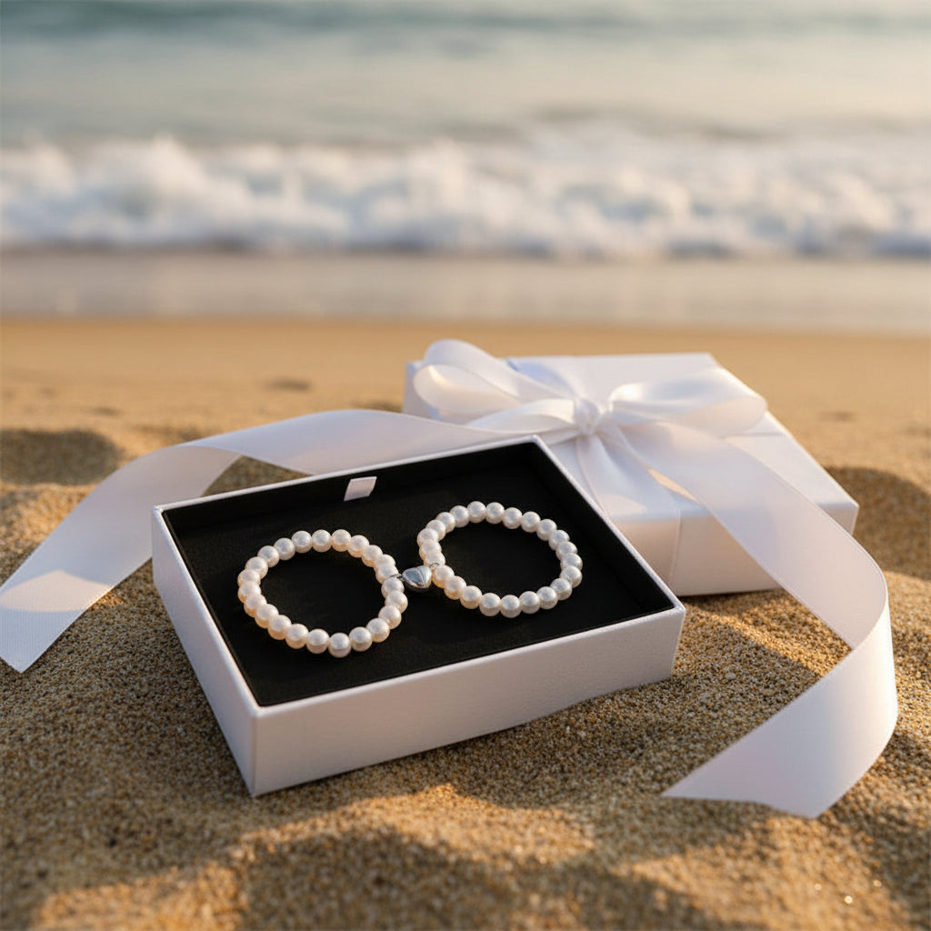 Two pearl necklaces on a beige background
