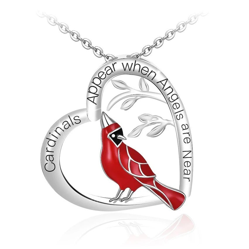 Silver necklace with a red cardinal bird pendant on a white background