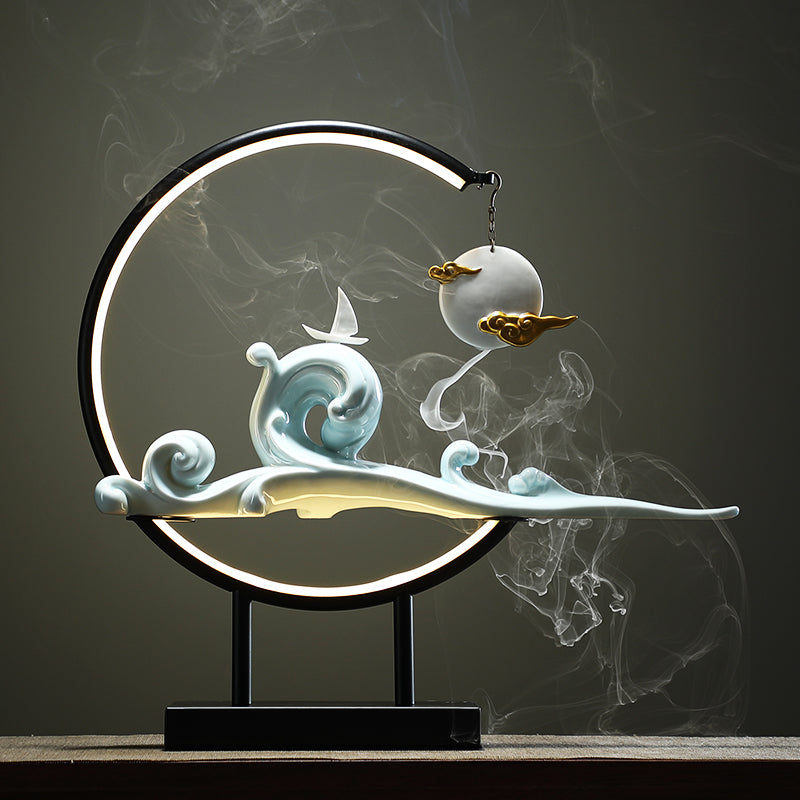 Decorative lamp with wave and cloud design on a dark background  incense burner