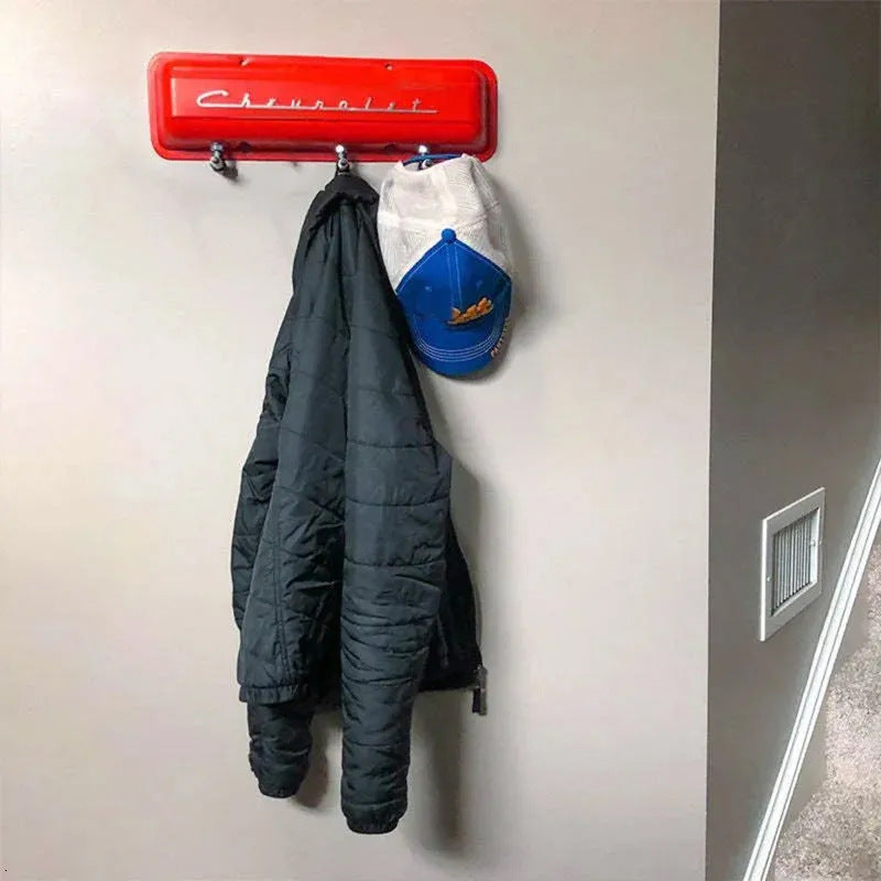 “Coat hanging on red valve cover rack—entryway display”