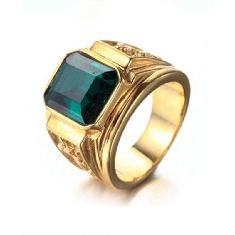 Gold ring with a green gemstone on a white background