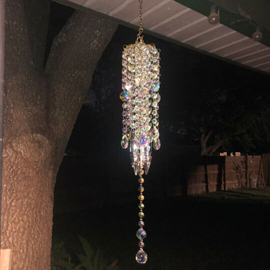 Decorative hanging crystal chandelier wind chime against a dark background