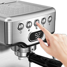 Hand adjusting settings on a coffee machine with digital display