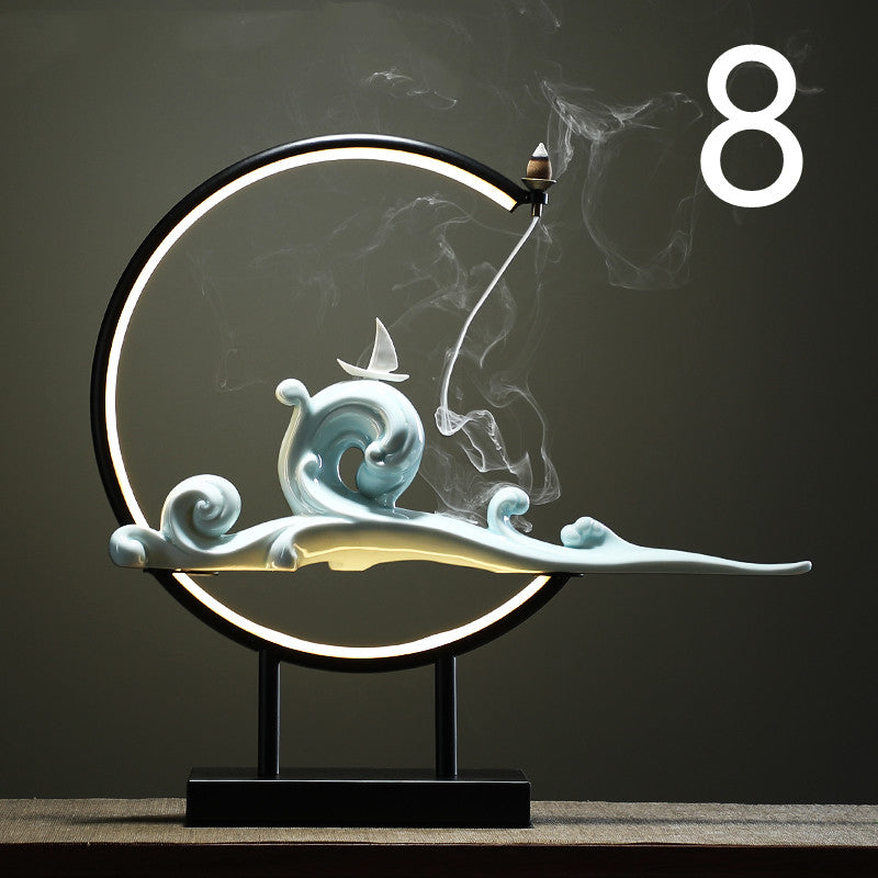 Decorative lamp with wave and cloud design on a dark background incense burner