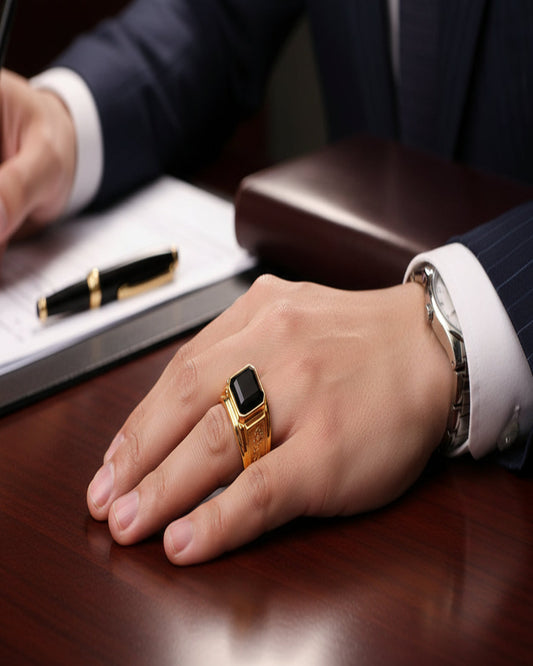 Gold ring with a black gemstone on a business mans hand