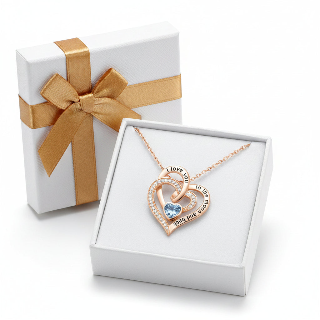 Birthstone Rose gold heart-shaped pendant with blue gemstone and engraved text on a white background