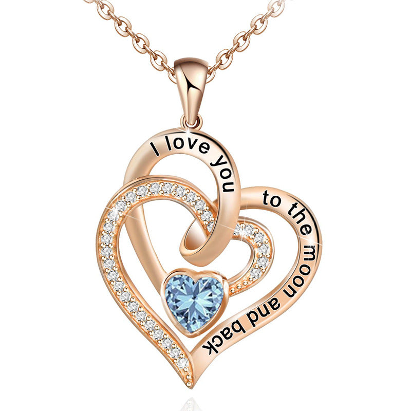 Birthstone Rose gold heart-shaped pendant with blue gemstone and engraved text on a white background