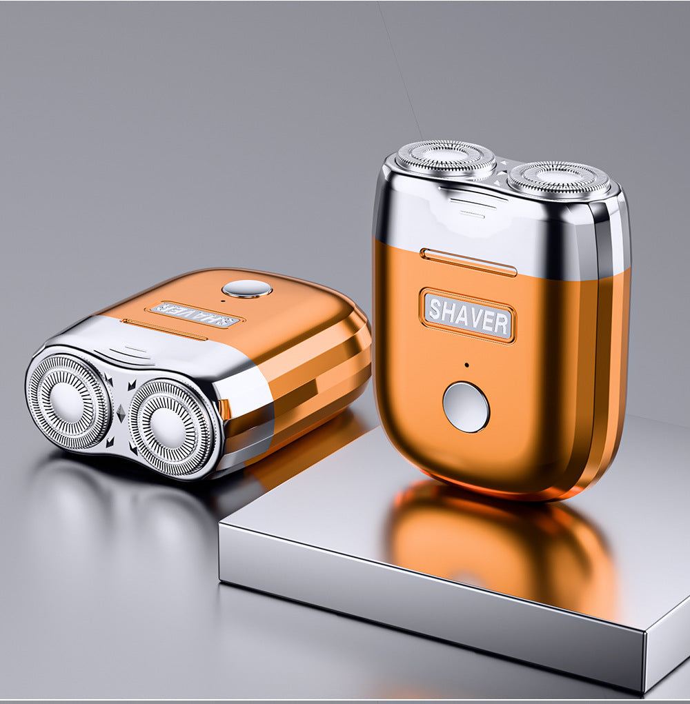 Orange and silver shaver on a reflective surface with a gray background