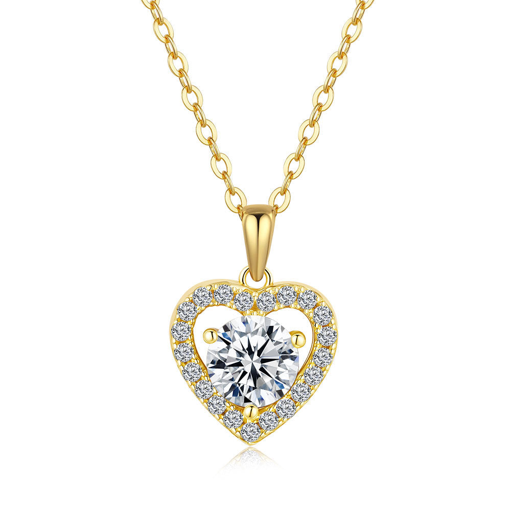 Gold heart-shaped necklace with a clear gemstone on a white background