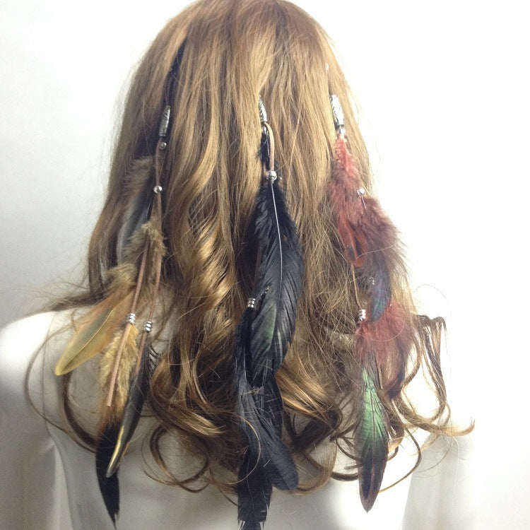 Feather hair extensions worn by a person with long, wavy hair on a white background