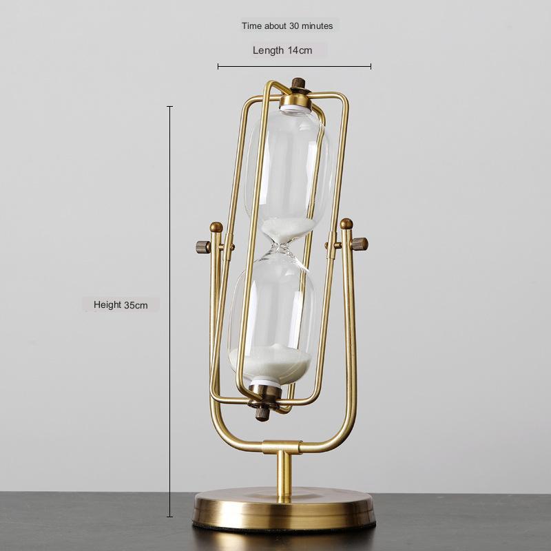Gold hourglass-shaped lamp with measurements on a gray background