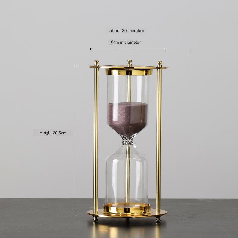 Gold hourglass with measurements on a gray background