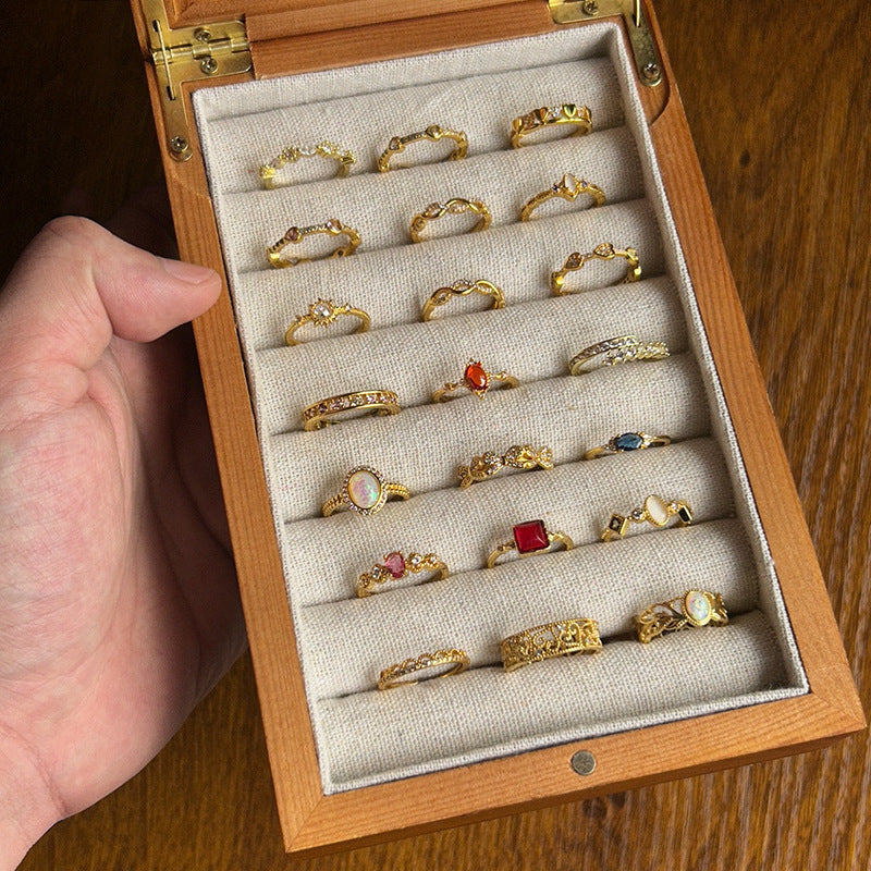 Wooden ring box with gold rings on a wooden surface
