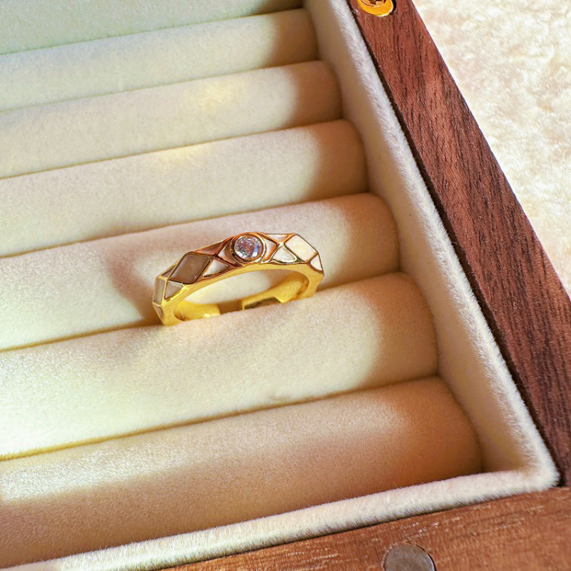 Gold ring with gemstones in a wooden jewelry box