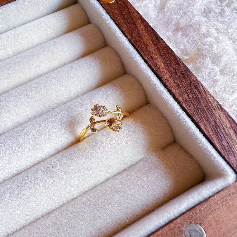 Gold ring with floral design in a jewelry box