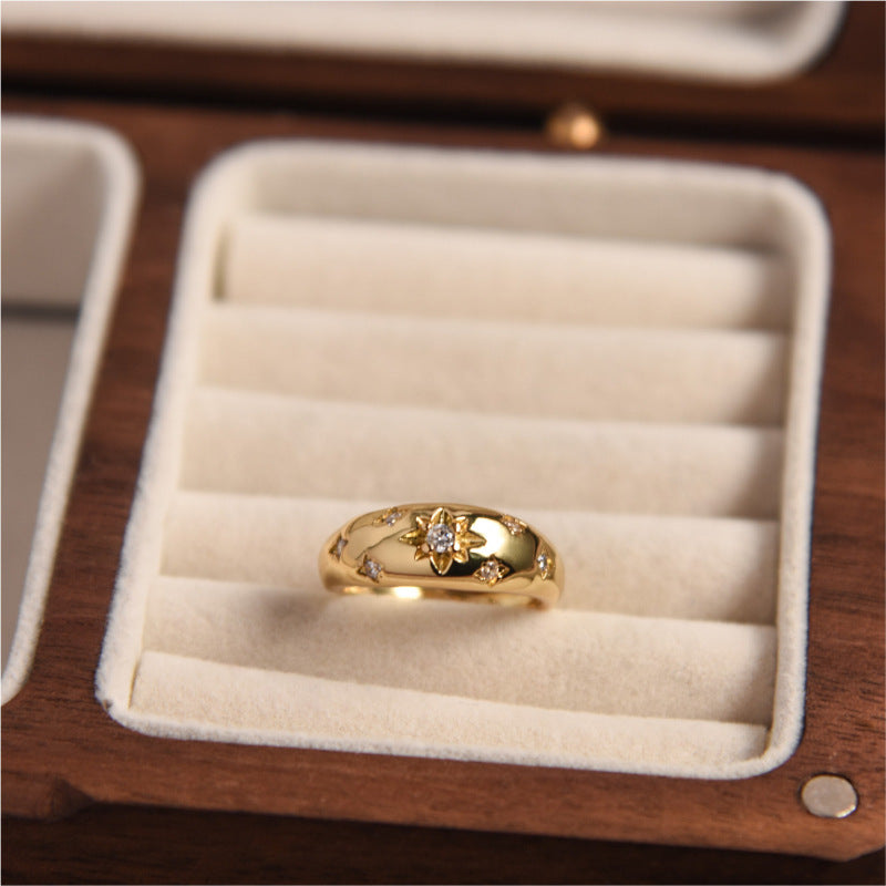 Gold ring with a diamond in a wooden jewelry box